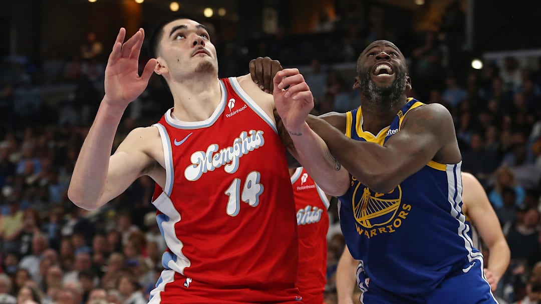 Apr 1, 2025; Memphis, Tennessee, USA; Memphis Grizzlies center Zach Edey (14) and Golden State Warriors forward Draymond Green (23) battle for position during the fourth quarter at FedExForum. Mandatory Credit: Petre Thomas-Imagn Images