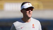Oct 28, 2023; Berkeley, California, USA; USC Trojans head coach Lincoln Riley (center) walks on the field before the game against the California Golden Bears at California Memorial Stadium. Mandatory Credit: Darren Yamashita-Imagn Images