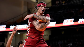 Arkansas forward Trevon Brazile (4) scoops up the ball against Vanderbilt during the first half at Memorial Gym in Nashville, Tenn., Tuesday, March 4, 2025.