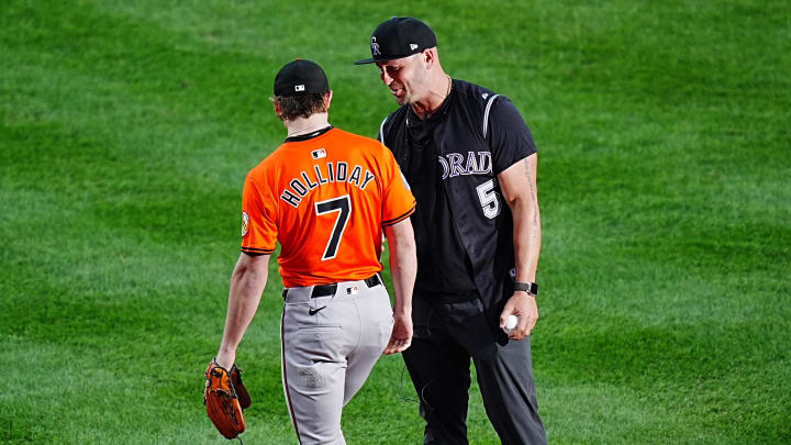 Aug 31, 2024; Denver, Colorado, USA; Baltimore Orioles second base Jackson Holliday (7) and his father retired American baseball player Matt Holliday before the game against the Colorado Rockies at Coors Field. 