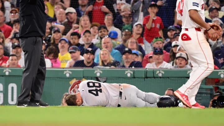 Jun 16, 2024; Boston, Massachusetts, USA; New York Yankees first baseman Anthony Rizzo (48) trips on Boston Red Sox pitcher Brennan Bernardino (not pictured) and rolls on the ground during the seventh inning at Fenway Park. Mandatory Credit: Eric Canha-USA TODAY Sports