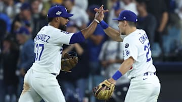 Oct 27, 2025; Los Angeles, California, USA; Los Angeles Dodgers right fielder Teoscar Hernandez (37) celebrates with second baseman Tommy Edman (25) after the tenth inning against the Toronto Blue Jays in game three of the 2025 MLB World Series at Dodger Stadium. Mandatory Credit: Kiyoshi Mio-Imagn Images