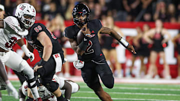 Sep 9, 2023; Piscataway, New Jersey, USA; Rutgers Scarlet Knights quarterback Gavin Wimsatt (2) carries the ball as Temple Owls linebacker Tra Thomas (30) pursues during the first half at SHI Stadium. 
