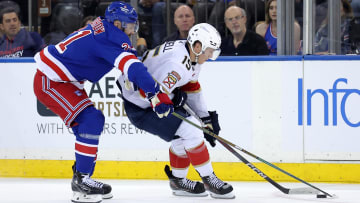 May 22, 2024; New York, New York, USA; Florida Panthers center Anton Lundell (15) skates with the puck against New York Rangers center Barclay Goodrow (21) during the second period of game one of the Eastern Conference Final of the 2024 Stanley Cup Playoffs at Madison Square Garden. Mandatory Credit: Brad Penner-USA TODAY Sports