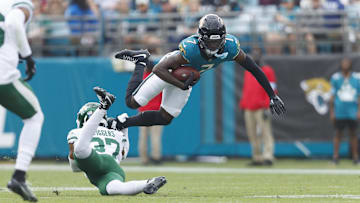 Dec 15, 2024; Jacksonville, Florida, USA; New York Jets cornerback Qwan'tez Stiggers (37) tackles Jacksonville Jaguars wide receiver Brian Thomas Jr. (7) during the first quarter at EverBank Stadium. Mandatory Credit: Morgan Tencza-Imagn Images
