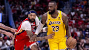 Apr 16, 2024; New Orleans, Louisiana, USA; Los Angeles Lakers forward LeBron James (23) dribbles against New Orleans Pelicans forward Brandon Ingram (14) during the second half of a play-in game of the 2024 NBA playoffs at Smoothie King Center. 