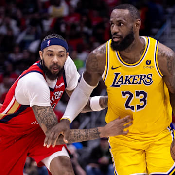 Apr 16, 2024; New Orleans, Louisiana, USA; Los Angeles Lakers forward LeBron James (23) dribbles against New Orleans Pelicans forward Brandon Ingram (14) during the second half of a play-in game of the 2024 NBA playoffs at Smoothie King Center. 