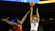 Nov 3, 2025; Los Angeles, California, USA;  UCLA Bruins guard Trent Perry (0) shoots the ball over Eastern Washington Eagles forward Kiree Huie (15) during the second half at Pauley Pavilion presented by Wescom Financial. Mandatory Credit: Kiyoshi Mio-Imagn Images