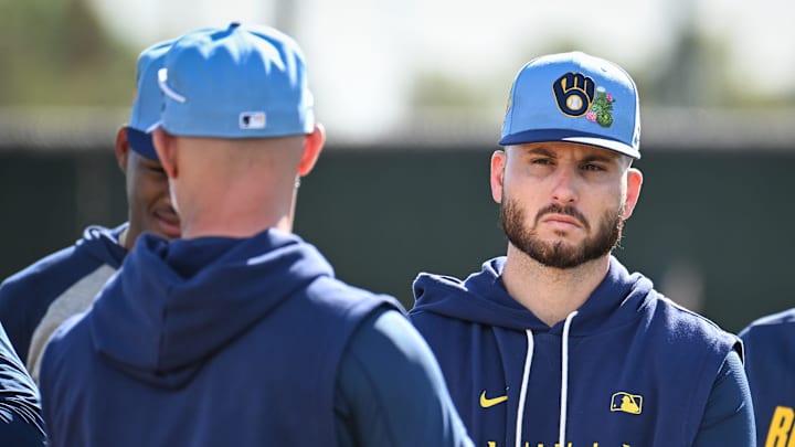 Milwaukee Brewers pitcher Peter Strzelecki listens to instruction from third base coach Matt Erickson before pitchers fielding drills during spring training workouts Sunday, February 15, 2026, at American Family Fields of Phoenix in Phoenix, Arizona.