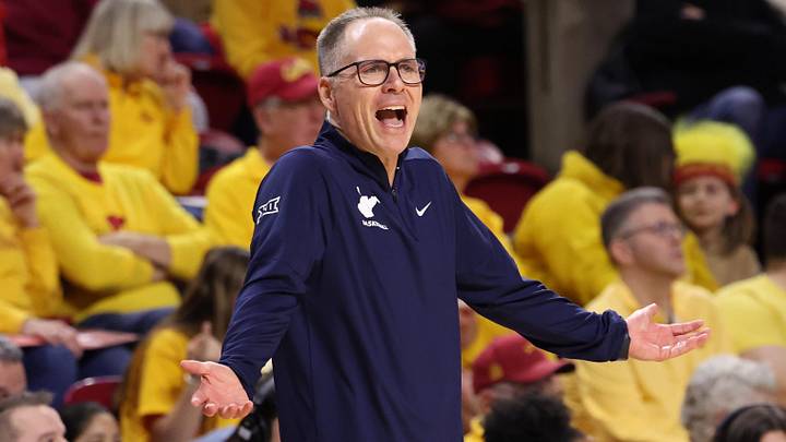 Jan 11, 2026; Ames, Iowa, USA; West Virginia Mountaineers head coach Mark Kellogg watches his team play the Iowa State Cyclones during the first half at James H. Hilton Coliseum. Mandatory Credit: Reese Strickland-Imagn Images