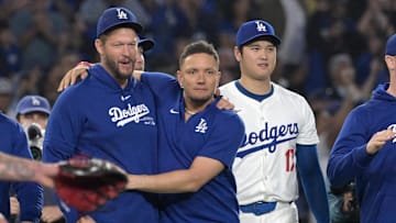 Sep 26, 2024; Los Angeles, California, USA;  Los Angeles Dodgers starting pitcher Clayton Kershaw (22), shortstop Miguel Rojas (11) and designated hitter Shohei Ohtani (17) after clinching the National League West by defeating the San Diego Padres 7-2 at Dodger Stadium. Mandatory Credit: Jayne Kamin-Oncea-Imagn Images
