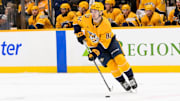 Jan 29, 2025; Nashville, Tennessee, USA;  Nashville Predators center Tommy Novak (82) skates with the puck against the Vancouver Canucks during the second period at Bridgestone Arena. Mandatory Credit: Steve Roberts-Imagn Images