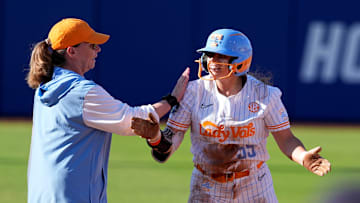 Tennessee's Gabby Leach (55) celebrates a triple with coach Karen Weekly in the first inning the Women's College World Series softball game between the Florida Gators and the Tennessee Volunteers at Devon Park in Oklahoma City, Friday, May, 30, 2025.