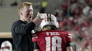 Injured Wisconsin quarterback Billy Edwards Jr. congratulates quarterback Danny O'Neil after a touchdown pass during the fourth quarter of their game Thursday, August 28, 2025 at Camp Randall Stadium in Madison, Wisconsin. Wisconsin beat Miami (Ohio) 17-0.