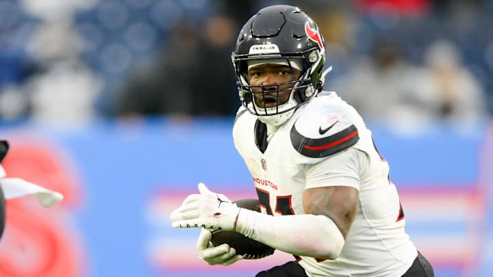 Jan 5, 2025; Nashville, Tennessee, USA; Former Houston Texans running back Dameon Pierce (31) runs the ball against the Tennessee Titans during the second half at Nissan Stadium.