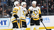 Jan 20, 2025; Los Angeles, California, USA;  Pittsburgh Penguins left wing Anthony Beauvillier (72, center) celebrates with center Sidney Crosby (87) and defenseman Kris Letang (58) after scoring a goal during the third period at Crypto.com Arena. Mandatory Credit: Kiyoshi Mio-Imagn Images