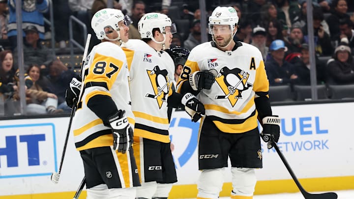 Jan 20, 2025; Los Angeles, California, USA;  Pittsburgh Penguins left wing Anthony Beauvillier (72, center) celebrates with center Sidney Crosby (87) and defenseman Kris Letang (58) after scoring a goal during the third period at Crypto.com Arena. Mandatory Credit: Kiyoshi Mio-Imagn Images