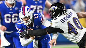 Teddye Buchanan tries to corral Bills quarterback Josh Allen in a game last month