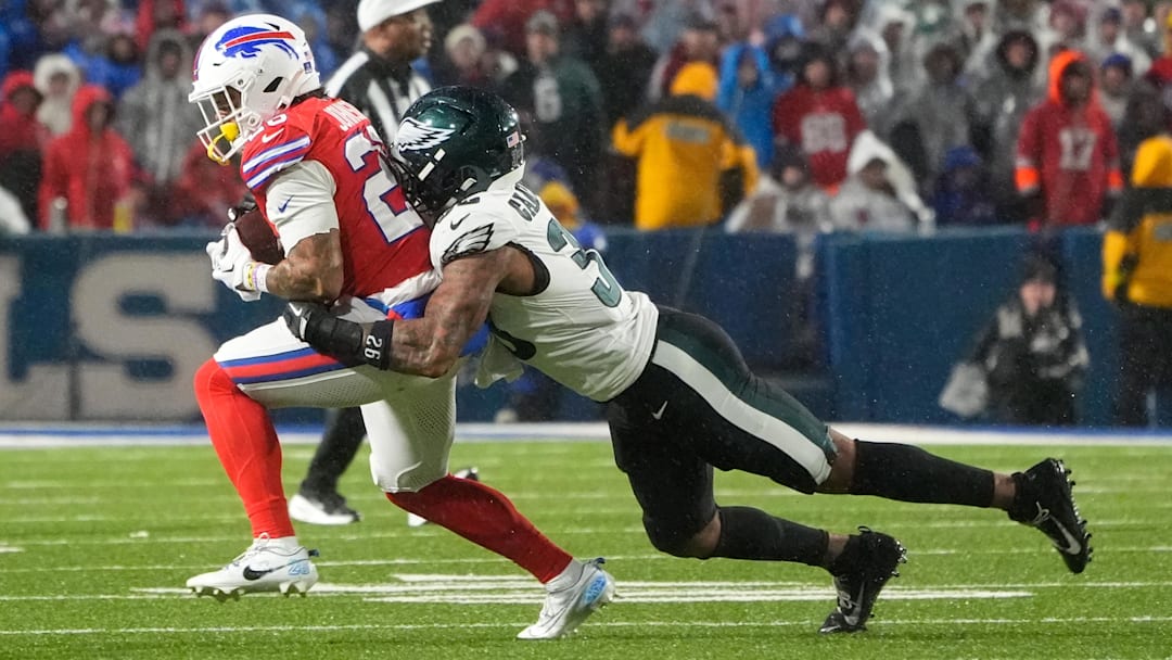 Dec 28, 2025; Orchard Park, New York, USA; Buffalo Bills running back Ty Johnson (26) runs the ball against Philadelphia Eagles cornerback Michael Carter II (35) during the third quarter at Highmark Stadium. Mandatory Credit: Gregory Fisher-Imagn Images