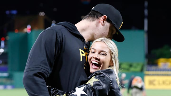 May 11, 2024; Pittsburgh, Pennsylvania, USA; Pittsburgh Pirates starting pitcher Paul Skenes (30) is embraced by his girlfriend Louisiana State University gymnast Olivia Dunne (right) after Skenes made his major league debut against the Chicago Cubs at PNC Park. May 11, 2024; Pittsburgh, Pennsylvania, USA; Pittsburgh Pirates starting pitcher Paul Skenes (30) is embraced by his girlfriend Louisiana State University gymnast Olivia Dunne (right) after Skenes made his major league debut against the Chicago Cubs at PNC Park.