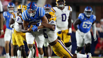 Sep 30, 2023; Oxford, Mississippi, USA; Mississippi Rebels tight end Caden Prieskorn (86) runs after a catch as LSU Tigers defensive backs Major Burns (8) and Jordan Allen (6) make the tackle during the second half  at Vaught-Hemingway Stadium. Mandatory Credit: Petre Thomas-USA TODAY Sports