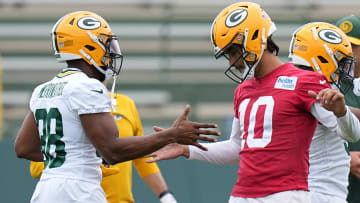 Green Bay Packers quarterback Jordan Love (10) clowns around with running back Ellis Merriweather(38) during organized team activities Tuesday, May 21, 2024 in Green Bay, Wisconsin.