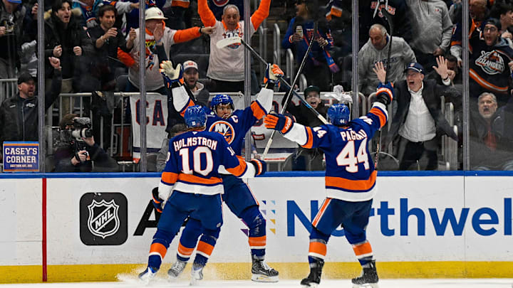 Mar 1, 2026; Elmont, New York, USA; New York Islanders center Jean-Gabriel Pageau (44) and New York Islanders right wing Simon Holmstrom (10) celebrate the by goal New York Islanders left wing Anders Lee (27) against the Florida Panthers during the third period at UBS Arena. Mandatory Credit: Dennis Schneidler-Imagn Images