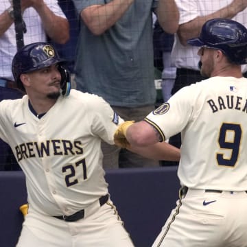 Milwaukee Brewers first baseman Jake Bauers (9) is congratulated by shortstop Willy Adames (27) after hitting a grand slam home run off of Texas Rangers pitcher Nathan Eovaldi during the third inning of their game Wednesday, June 26, 2024 at American Family Field in Milwaukee, Wisconsin.
