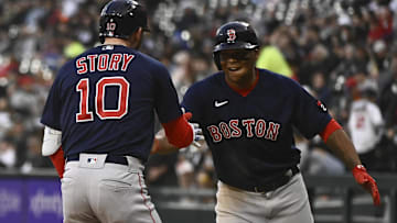 Boston Red Sox second baseman Trevor Story (10), right, celebrates with Boston Red Sox third baseman Rafael Devers, right, after they score on Story's three-run home run during the first inning against the Chicago White Sox at Guaranteed Rate Field.