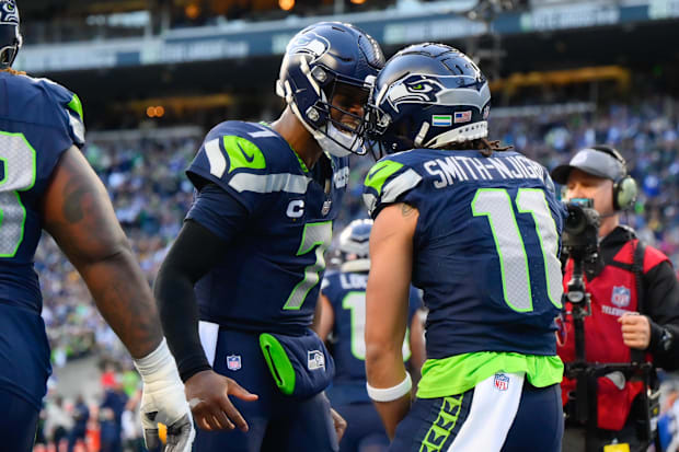 Seattle Seahawks quarterback Geno Smith (7) and wide receiver Jaxon Smith-Njigba (11) celebrate.