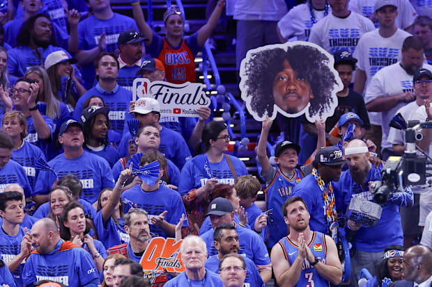A fan holds up a cutout of Jalen Williams during the fourth quarter of Game 5 in the NBA Finals.