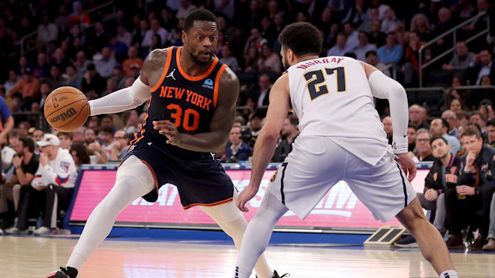 Jan 25, 2024; New York, New York, USA; New York Knicks forward Julius Randle (30) controls the ball against Denver Nuggets guard Jamal Murray (27) during the third quarter at Madison Square Garden. Mandatory Credit: Brad Penner-Imagn Images