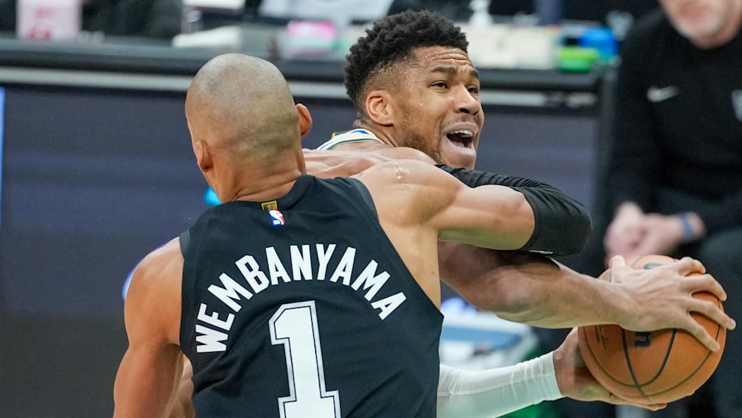 Jan 15, 2026; San Antonio, Texas, USA;  San Antonio Spurs forward/center Victor Wembanyama (1) fouls Milwaukee Bucks forward Giannis Antetokounmpo (34) in the first half at Frost Bank Center. Mandatory Credit: Daniel Dunn-Imagn Images