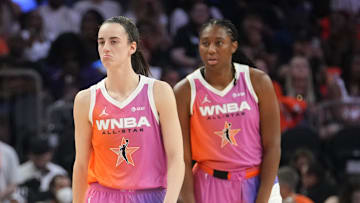 Team WNBA teammates Caitlin Clark (22), center, forward Aliyah Boston (7), right, and center Jonquel Jones (35) take on Team USA during the WNBA All-Star Game at Footprint Center in Phoenix on July 20, 2024.