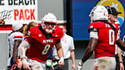 Sep 6, 2025; Raleigh, North Carolina, USA; North Carolina State Wolfpack linebacker Cian Slone (8) celebrates an interception with North Carolina State Wolfpack quarterback CJ Bailey (11) to win the game during the second half of the game against Virginia Cavaliers at Carter-Finley Stadium. Mandatory Credit: Jaylynn Nash-Imagn Images