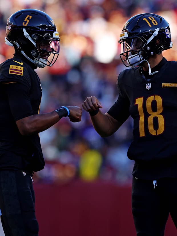 Washington Commanders quarterback Jayden Daniels (5) and quarterback Marcus Mariota (18).