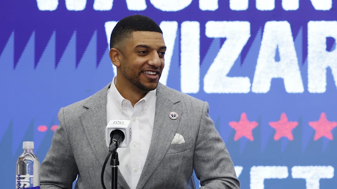 Jan 9, 2026; Washington, District of Columbia, USA; Washington Wizards general manager Will Dawkins (L) introduces newly acquired Wizards guard Trae Young (R) at a press conference prior to the Wizards' game against the New Orleans Pelicans at Capital One Arena. Mandatory Credit: Geoff Burke-Imagn Images