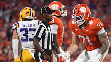 Clemson Tigers offensive lineman Tristan Leigh (71) helps up Clemson Tigers quarterback Cade Klubnik (2) Saturday, Aug. 30, 2025 during the NCAA football game against the LSU Tigers at Memorial Stadium in Clemson, South Carolina. LSU Tigers won 17-10.