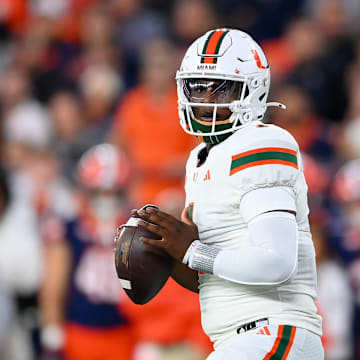Nov 30, 2024; Syracuse, New York, USA; Miami Hurricanes quarterback Cam Ward (1) looks to pass against the Syracuse Orange during the first half at the JMA Wireless Dome. Mandatory Credit: Rich Barnes-Imagn Images