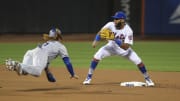Aug 6, 2017; New York City, NY, USA; Los Angeles Dodgers third baseman Justin Turner (10) tries to beat the tag from New York Mets shortstop Amed Rosario (1) in the first inning at Citi Field. Mandatory Credit: Wendell Cruz-USA TODAY Sports