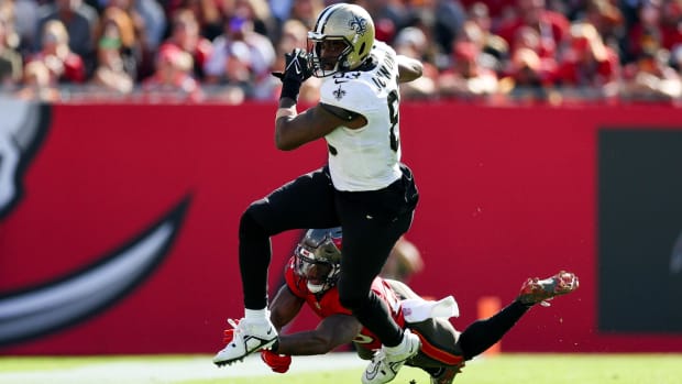 New Orleans Saints tight end Juwan Johnson (83) breaks a tackle after a reception against the Tampa Bay Buccaneers 