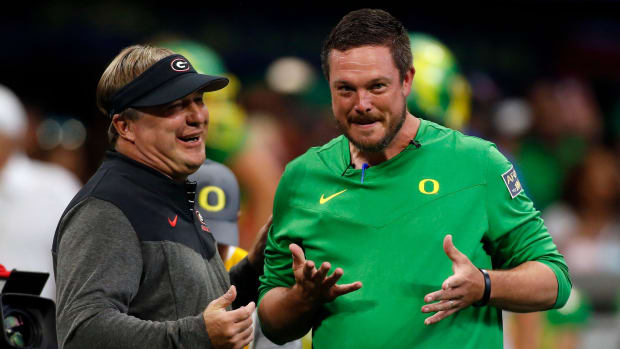 Georgia head coach Kirby Smart and Oregon head coach Dan Lanning meet during warm ups before the start of the Chick-fil-A Kic