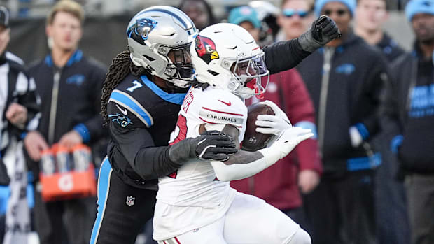 Arizona Cardinals running back Michael Carter chased down by Carolina Panthers linebacker Jadeveon Clowney.