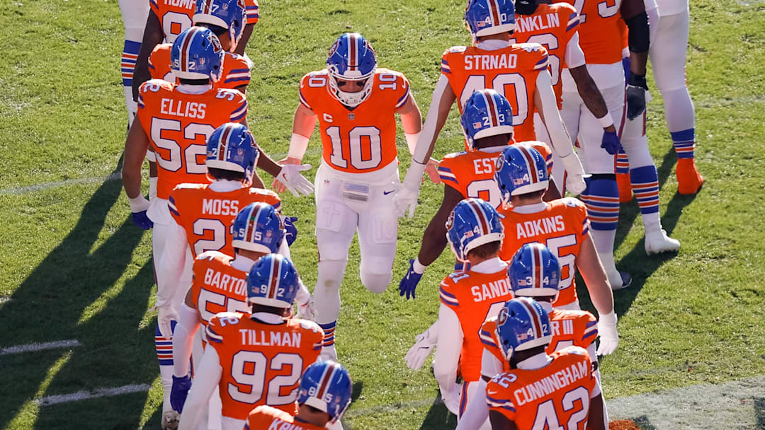 Jan 5, 2025; Denver, Colorado, USA; Denver Broncos quarterback Bo Nix (10) runs out during player introductions before the game against the Kansas City Chiefs at Empower Field at Mile High. 