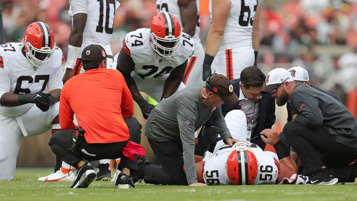 Cleveland Browns center Luke Wypler (56) is checked on by staff after an injury during the first half of an NFL preseason football game at Cleveland Browns Stadium, Saturday, Aug. 10, 2024, in Cleveland, Ohio.