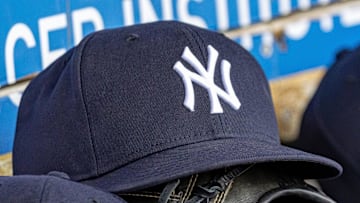 Apr 7, 2025; Detroit, Michigan, USA; New York Yankees baseball hats and gloves in the dugout out in the eighth inning against the Detroit Tigers at Comerica Park.