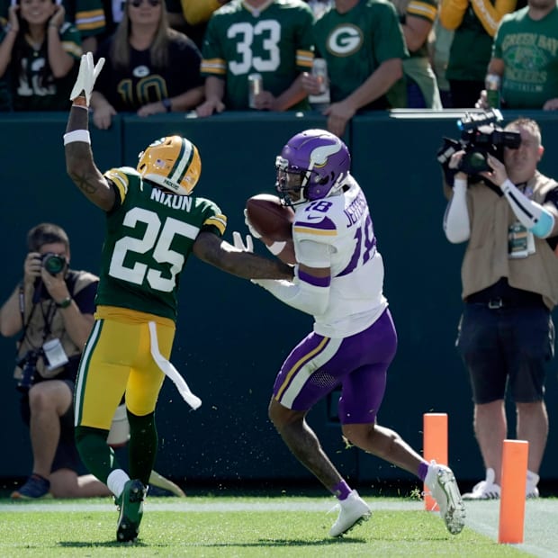 Minnesota Vikings wide receiver Justin Jefferson (18) scores a touchdown on Green Bay Packers cornerback Keisean Nixon.