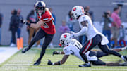 Northern Illinois Huskies wide receiver Dane Pardridge (23) eludes Arkansas State Red Wolves defensive back Denzel Blackwell (14) and defensive back James Reed III (19) in the Camellia Bowl at Cramton Bowl in Montgomery, Ala., on Saturday December 23, 2023.