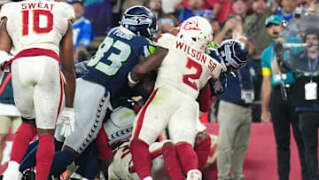 Sep 25, 2025; Glendale, Arizona, USA;  Seattle Seahawks running back Zach Charbonnet (26) scores a touchdown against Arizona Cardinals linebacker Mack Wilson Sr. (2) in the second quarter at State Farm Stadium. Mandatory Credit: Joe Camporeale-Imagn Images