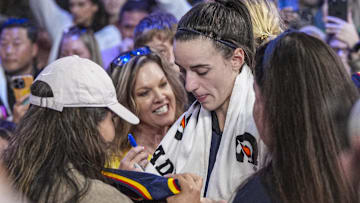 May 10, 2025; Atlanta, GA, USA; Indiana Fever guard Caitlin Clark (22) signs autographs on her way off the court after the Fever defeated the Atlanta Dream at Gateway Center Arena @ College Park. Mandatory Credit: Dale Zanine-Imagn Images